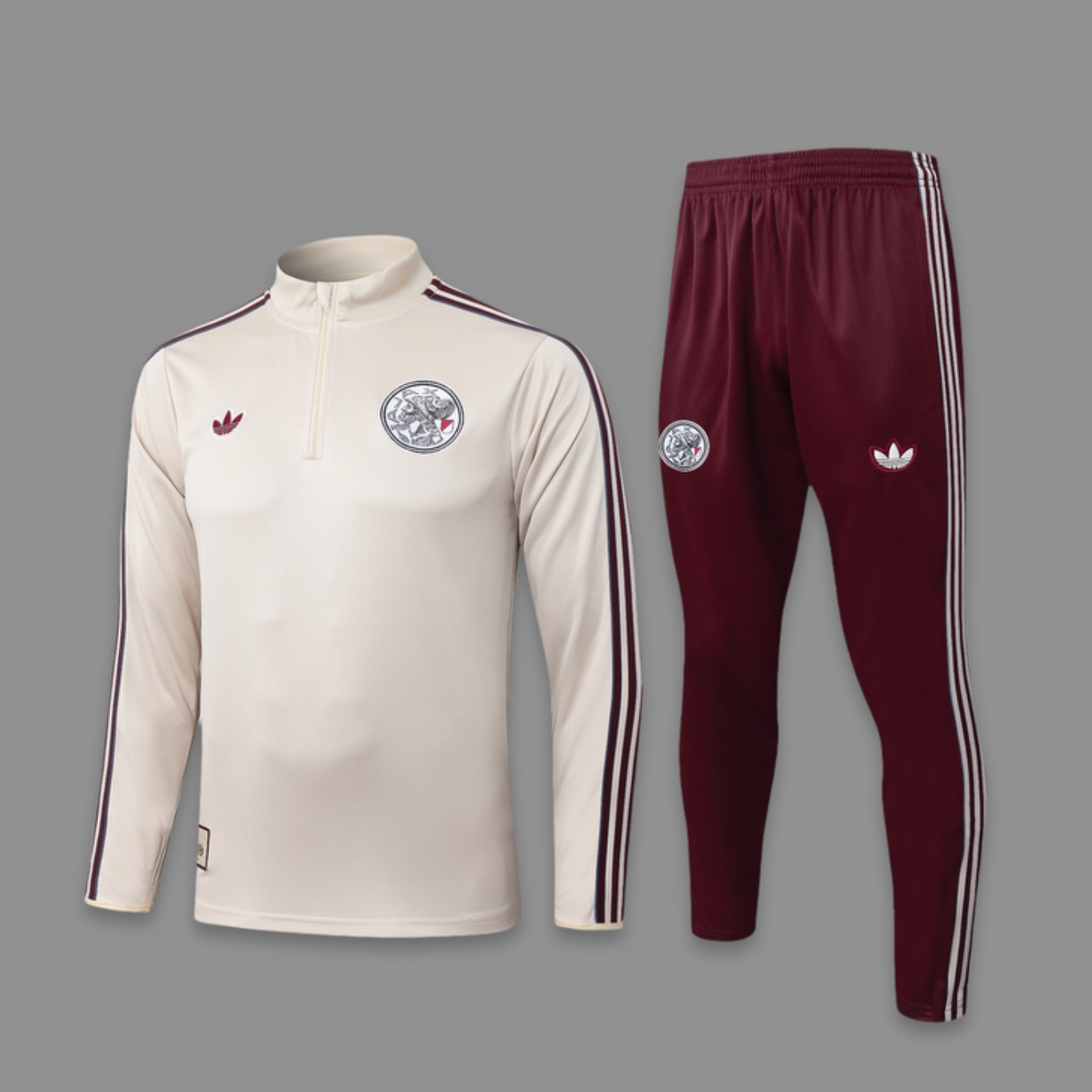 Beige tracksuit with maroon pants featuring Adidas logo on a gray background